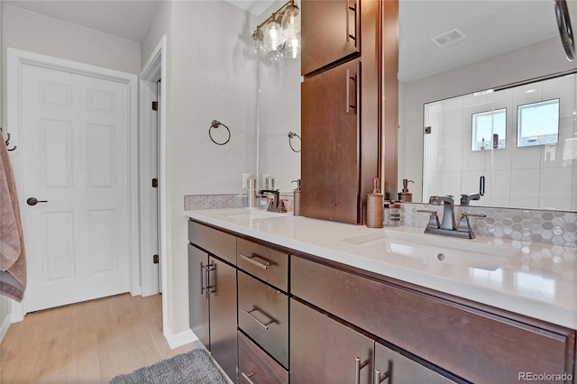21900 E 46th Pl, Aurora, CO 80019 - bathroom with double vanity, wood finished floors, and baseboards