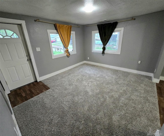 520 Prairie Rd, Colorado Springs, CO 80909 - carpeted entrance foyer featuring a textured ceiling and baseboards