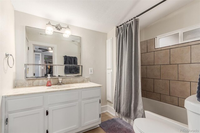 520 Prairie Rd, Colorado Springs, CO 80909 - bathroom with toilet, vanity, shower / tub combo with curtain, and ceiling fan