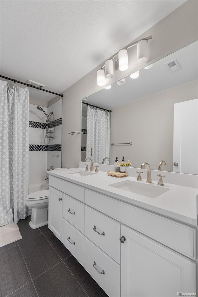 full bathroom featuring toilet, tile patterned floors, vanity, a textured ceiling, and shower / tub combo with curtain