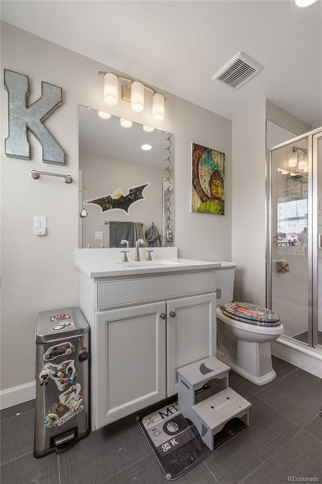 bathroom with tile patterned flooring, walk in shower, and vanity