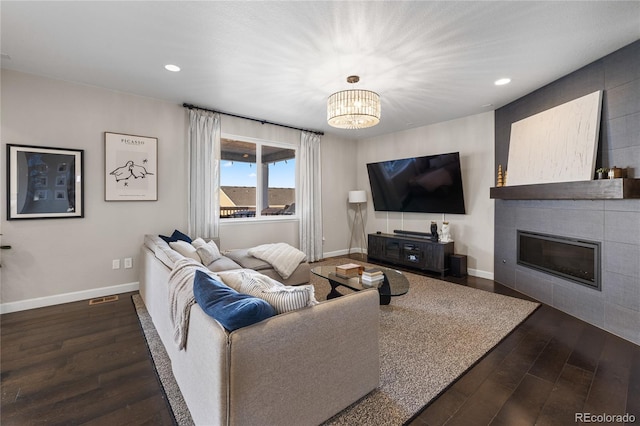 living room with hardwood / wood-style flooring and a notable chandelier