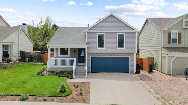 7767 Elmwood St, Littleton, CO 80125 - view of front of property featuring covered porch, a garage, and driveway