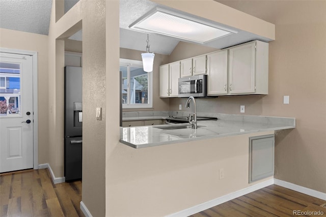 7767 Elmwood St, Littleton, CO 80125 - kitchen with stainless steel microwave, fridge with ice dispenser, lofted ceiling, dark wood-style floors, and white cabinets
