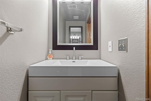 7767 Elmwood St, Littleton, CO 80125 - bathroom featuring a textured wall and vanity