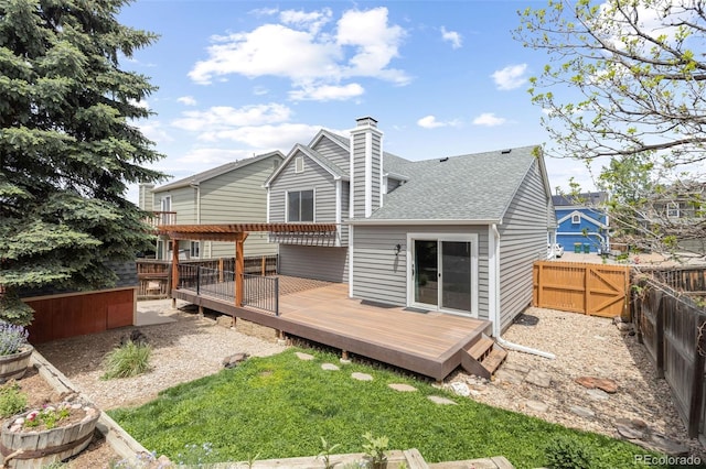 7767 Elmwood St, Littleton, CO 80125 - back of property featuring a wooden deck, a fenced backyard, a shingled roof, a chimney, and a pergola