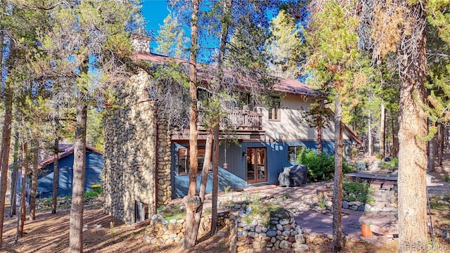 rear view of property with a patio area and a deck