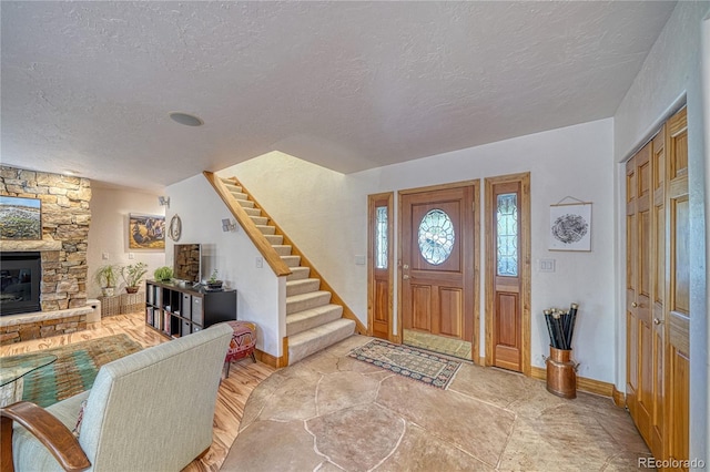 foyer with a fireplace and a textured ceiling