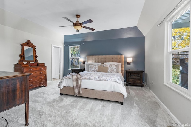 bedroom featuring vaulted ceiling, light colored carpet, and ceiling fan