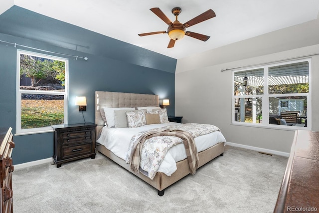 carpeted bedroom featuring lofted ceiling and ceiling fan