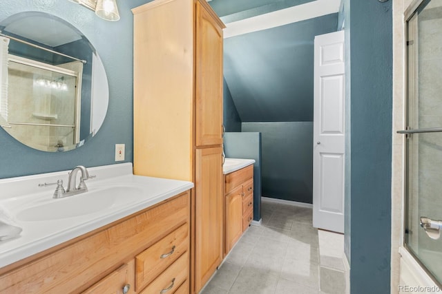 bathroom featuring vanity, tile patterned floors, and combined bath / shower with glass door