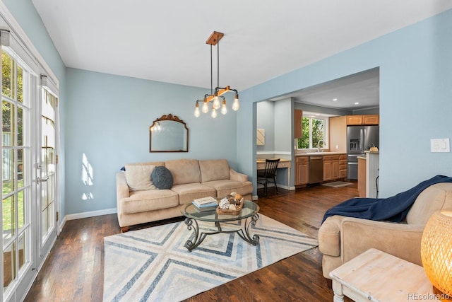 living room with dark hardwood / wood-style floors and sink