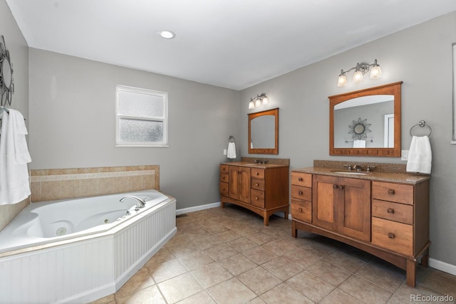 bathroom with tile patterned flooring, vanity, and a washtub