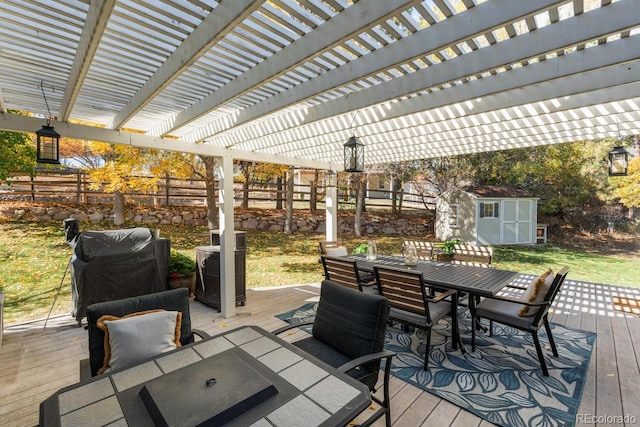 deck with a storage unit, grilling area, and a pergola