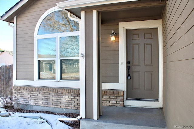 view of snow covered property entrance