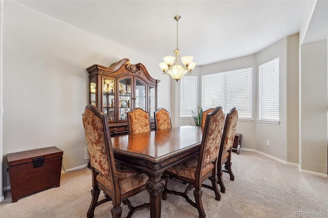 dining area with light carpet and an inviting chandelier