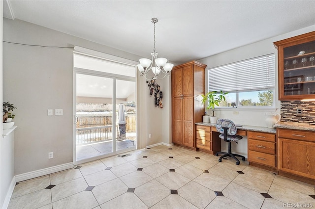 office area featuring an inviting chandelier and built in desk