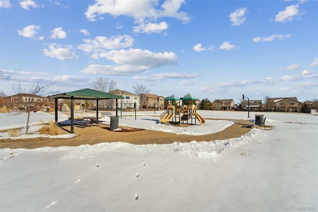 snow covered playground featuring a gazebo