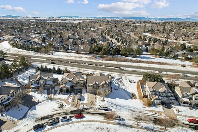 snowy aerial view with a mountain view