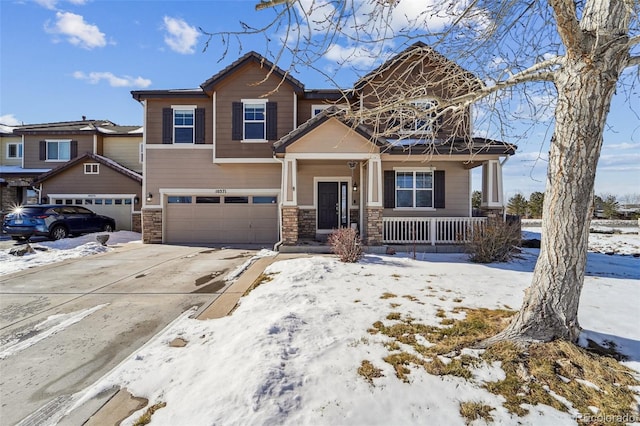 view of front of house with stone siding, covered porch, concrete driveway, and an attached garage