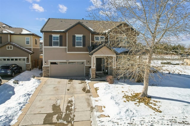 view of front of property with a tiled roof, concrete driveway, and a garage