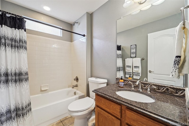 full bath with tile patterned floors, shower / tub combo with curtain, vanity, and toilet