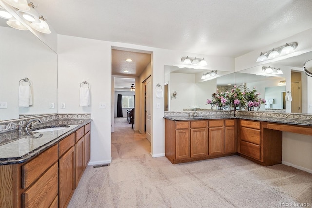 full bath with vanity, visible vents, baseboards, and ceiling fan