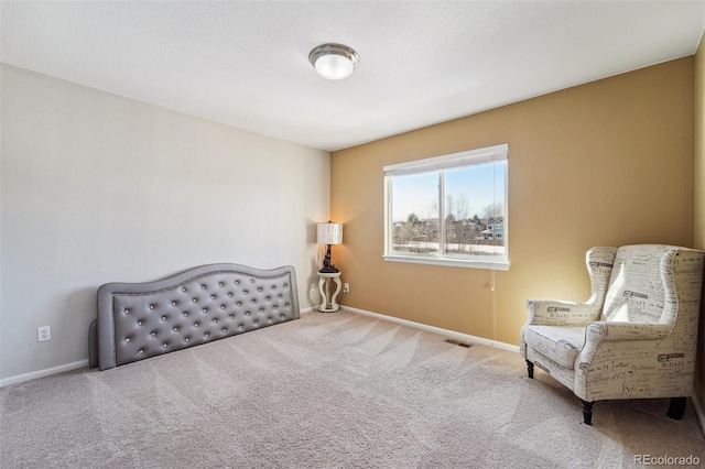 sitting room with visible vents, carpet flooring, and baseboards