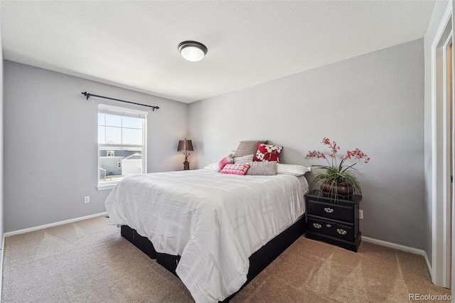 carpeted bedroom featuring baseboards