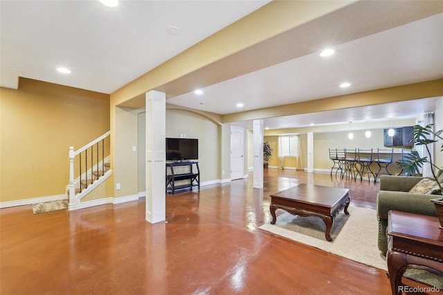 living room with stairs, recessed lighting, baseboards, and concrete floors