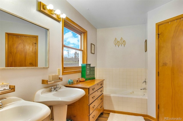 757 Thompson Park Rd, Fairplay, CO 80440 - bathroom with a sink, a bath, and wood finished floors