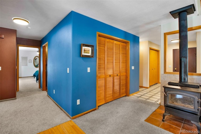 757 Thompson Park Rd, Fairplay, CO 80440 - living area featuring a wood stove, baseboards, and carpet floors