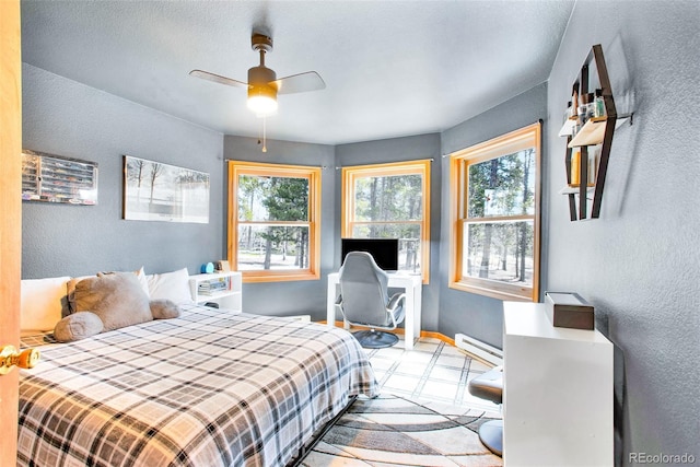 757 Thompson Park Rd, Fairplay, CO 80440 - bedroom featuring a textured wall, a baseboard radiator, a ceiling fan, and baseboards