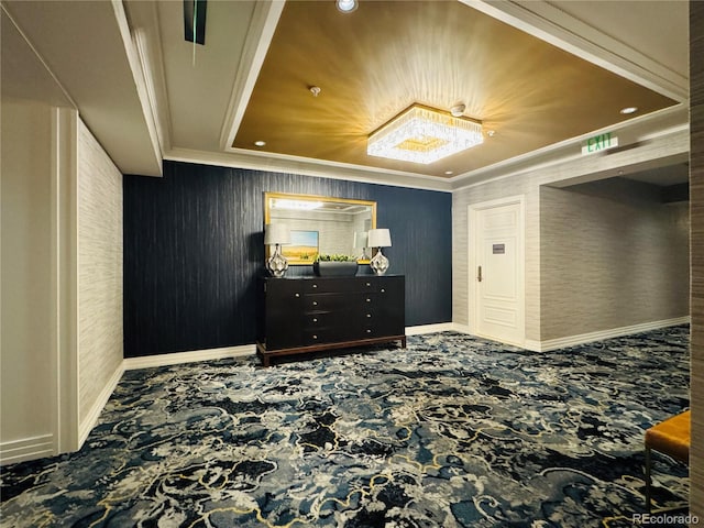 bedroom with a raised ceiling and crown molding