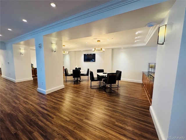 dining room with dark wood-type flooring and crown molding