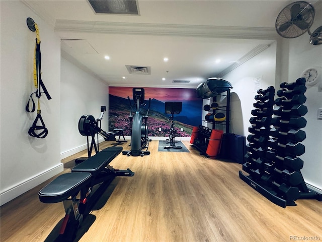 exercise room with wood-type flooring and ornamental molding