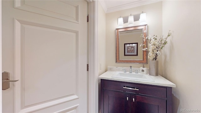 bathroom featuring crown molding and vanity