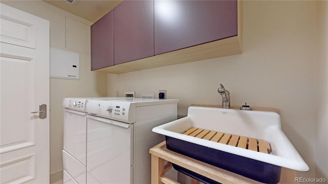 washroom with washing machine and clothes dryer and cabinets