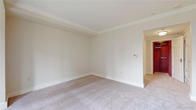 carpeted spare room with ornamental molding