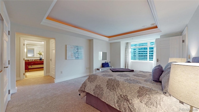 bedroom with ornamental molding, a tray ceiling, and light colored carpet