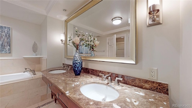 bathroom with tiled tub, vanity, and ornamental molding