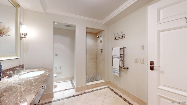 bathroom with tile patterned floors, toilet, tiled shower, vanity, and ornamental molding