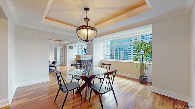 1891 Curtis St Unit 1613, Denver, CO 80202 - dining area with a tray ceiling, wood-type flooring, and ornamental molding