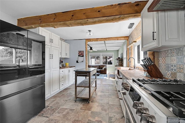 124 River Dr, Bailey, CO 80421 - kitchen with stainless steel range with gas stovetop, beamed ceiling, decorative backsplash, a ceiling fan, and extractor fan
