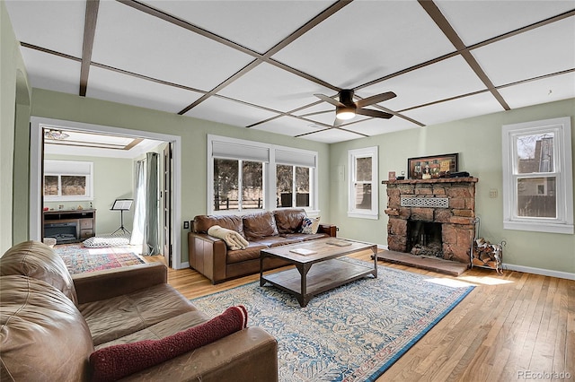 124 River Dr, Bailey, CO 80421 - living area with a fireplace, a ceiling fan, light wood-style floors, and baseboards