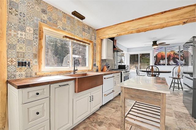 124 River Dr, Bailey, CO 80421 - kitchen with butcher block counters, dishwasher, white cabinets, a sink, and ceiling fan