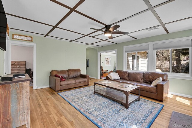 124 River Dr, Bailey, CO 80421 - living area with arched walkways, a ceiling fan, light wood-style flooring, and baseboards