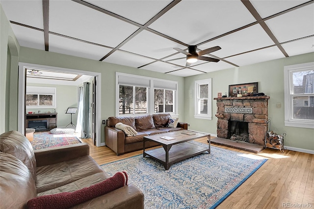124 River Dr, Bailey, CO 80421 - living area with a fireplace, light wood-type flooring, ceiling fan, and baseboards
