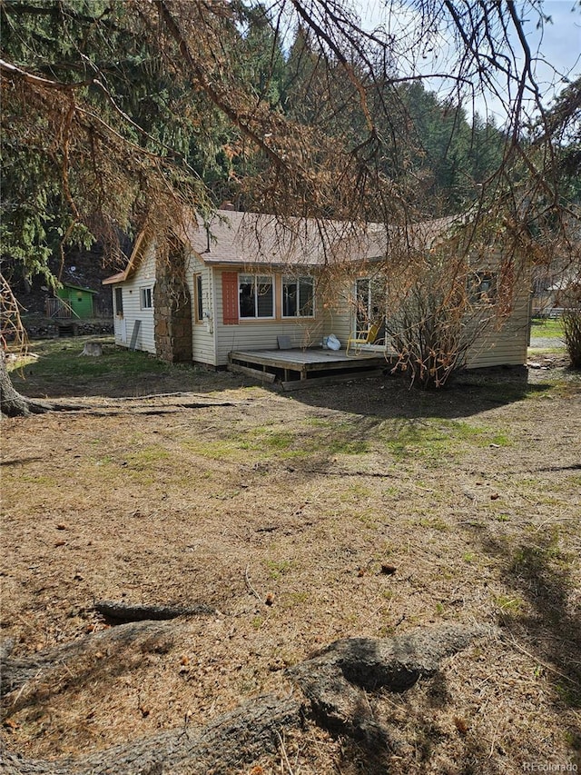 124 River Dr, Bailey, CO 80421 - rear view of house with a wooden deck and a yard
