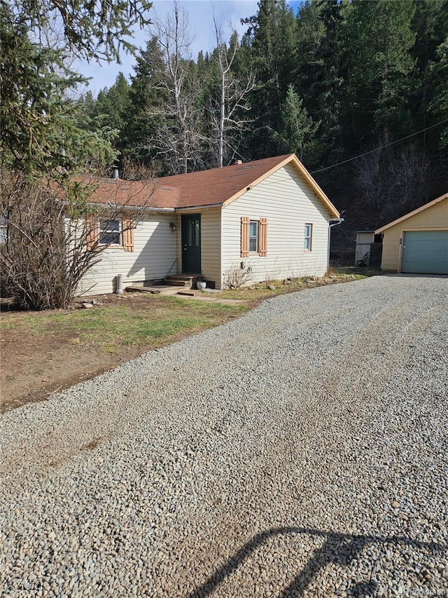124 River Dr, Bailey, CO 80421 - single story home featuring an outdoor structure, a garage, and driveway